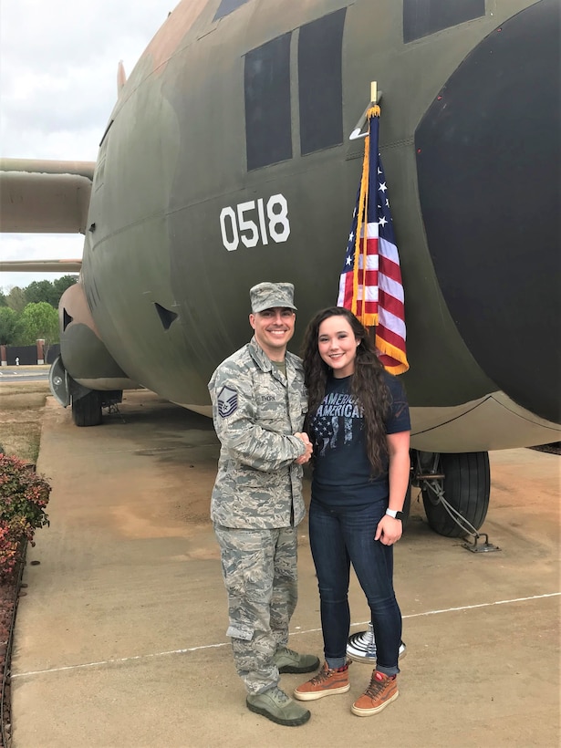 Master Sgt. Nathan Thorn, Reserve recruiter, congratulates Kristen Daniels on her enlistment on March 29, 2019, in front of the last C-130 Hercules that flew out of Vietnam.