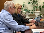 Photo of a man and woman sitting at a table with Q&A with Eastern Region staff members