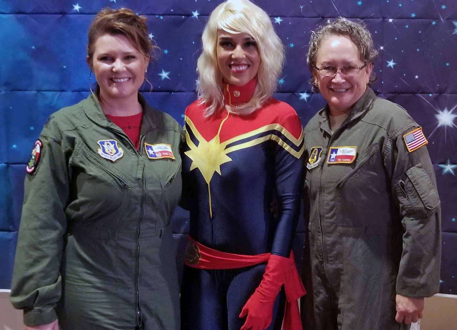 Lt. Col. Kari Hill (left), 433rd Operations Support Squadron commander/pilot, and Tech. Sgt. Debra Hill (right), 68th Airlift Squadron loadmaster, both with Joint Base San Antonio-Lackland, pose with Rebecca Sorenson, owner of Chic Basics, and a domestic engineer March 23 during the “Marvelous Women Don’t Need Capes” event at the Alamo Drafthouse movie cinema in San Antonio. The “Show them Everything Possible” Organization of San Antonio hosted the event.