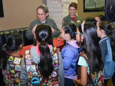 Tech. Sgt. Debra Harper (left), 68th Airlift Squadron loadmaster, and Lt. Col. Kari Hill, 433rd Operations Support Squadron commander/pilot, both with Joint Base San Antonio-Lackland, Texas, talk with girls attending the “Marvelous Women Don’t Need Capes” event. The event, which took place at the Alamo Drafthouse movie cinema, March 23, 2019, in San Antonio, introduces young girls to professional women heroes, who are “Marvelous” in their profession in the San Antonio area.