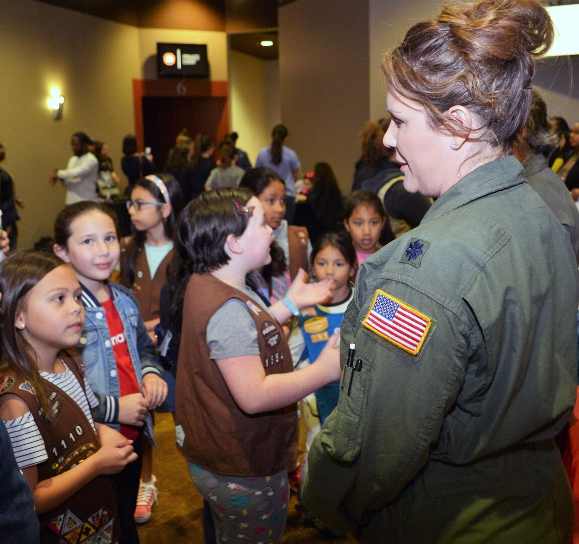Lt. Col. Kari Hill, a C-5M Super Galaxy aircraft pilot and squadron commander with the 433rd Operations Support Squadron, Joint Base San Antonio-Lackland, talks, one-on-one, with a group of girls attending the “Marvelous Women Don’t Need Capes” event. The event took place at the Alamo Drafthouse movie cinema March 23 in San Antonio. Hosted by the “Show them Everything Possible” Organization of San Antonio, the event creates a unique cultural and educational experience for youth to see various professions. At this event, S.T.E.P. introduces young girls to professional women heroes, who are “Marvelous” in their profession in the San Antonio area.