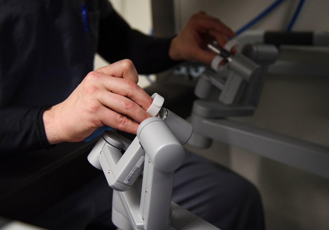 A surgeon uses his fingers to operate the da Vinci Surgery System.