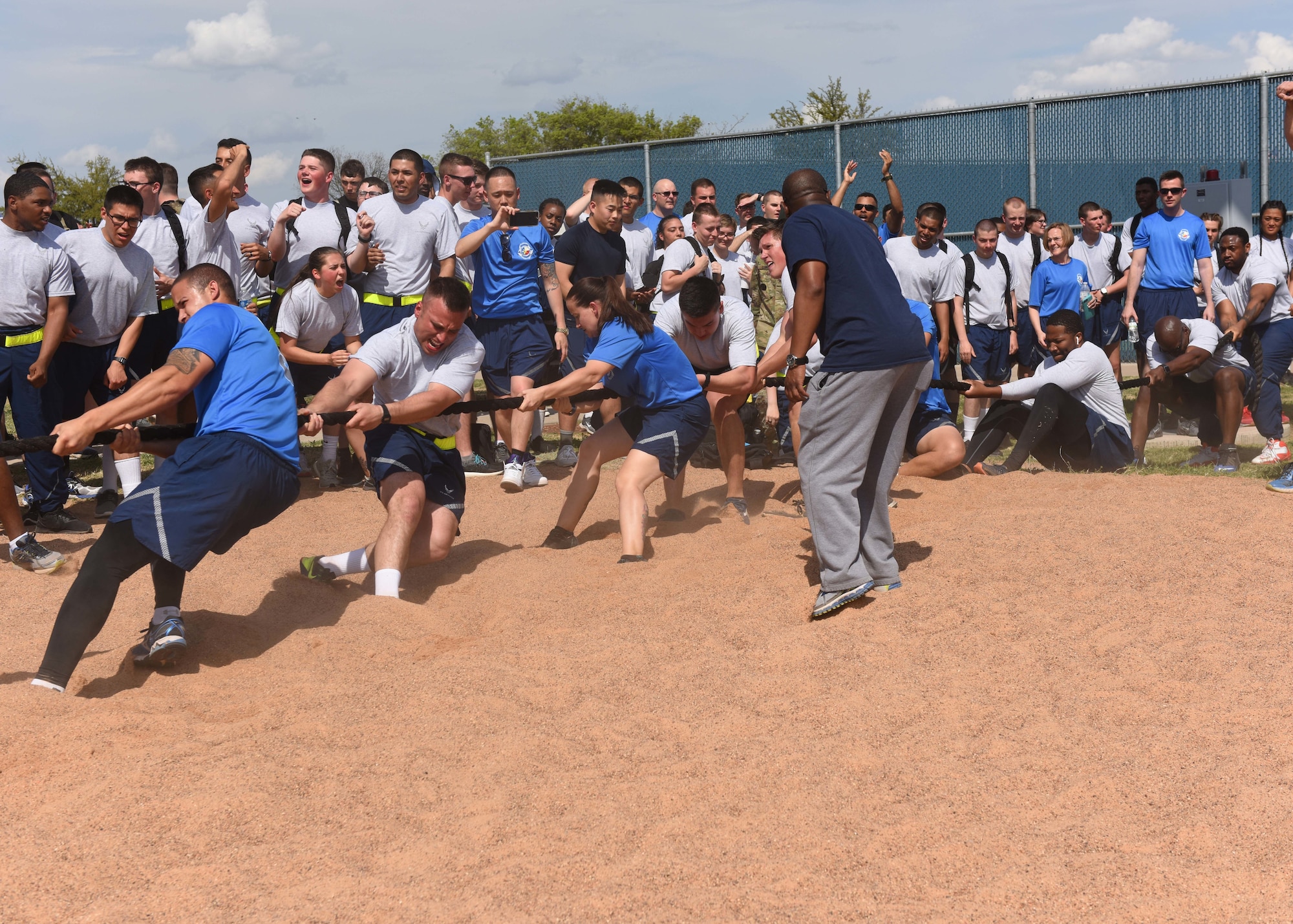 Members from the 316th Training Squadron compete in a tug of war against the 315th Training Squadron during Sports Day at the Mathis Fitness Center, Goodfellow Air Force Base, Texas, April 5, 2019. The different squadrons competed against each other throughout the day, and the four squadrons with the most points faced off in the tug of war. (U.S. Air Force photo by Airman 1st Class Zachary Chapman/Released)