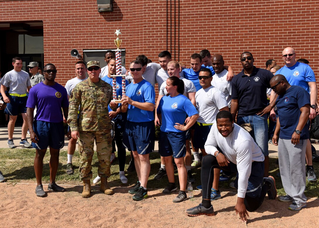U.S. Air Force Chief Master Sgt. Lavor Kirkpatrick, 17th Training Wing command chief, and Col. Robert Ramirez, 17th TRW vice commander, join members of the 316th Training Squadron for a photo on Sports Day at the Mathis Fitness Center, Goodfellow Air Force Base, Texas, April 5, 2019. The 316th TRS dethroned the 315th Training Squadron who had taken first for the last two Sports Days (U.S. Air Force photo by Airman 1st Class Zachary Chapman/Released)