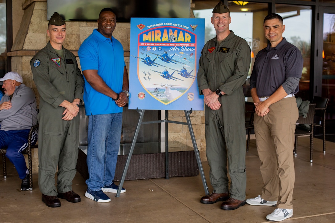 Col. Charles Dockery (far left), commanding officer of Marine Corps Air Station Miramar, and Brig. Gen. Michael J. Borgschulte (center right), assistant wing commander of 3rd Marine Aircraft Wing presents the theme of this year’s air show, ‘ A Salute to America’s First Responders’ at MCAS Miramar, Calif., April 5. The 2019 golf tournament was hosted in honor of America’s first responders. The event consisted mostly of active duty military members, veterans, firefighters and the San Diego Police Department. (U.S. Marine Corps photo by Cpl. Nadia J. Stark)