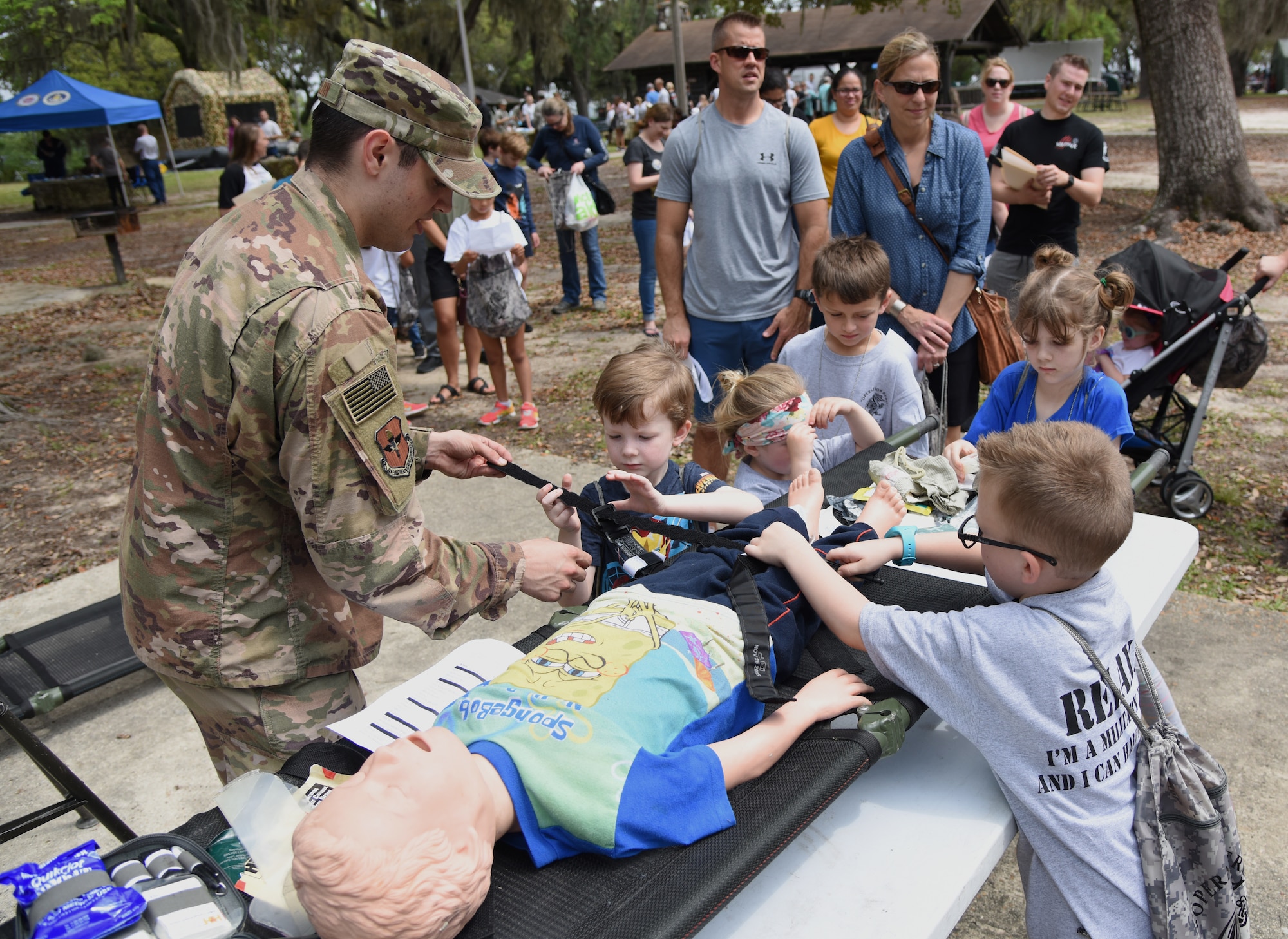 U.S. Air Force Senior Airman Brock Mauldin, 81st Medical Support Squadron education and training self aid buddy care wing advisor, provides a medical triage demonstration to military children during Operation Hero at Keesler Air Force Base, Mississippi, April 6, 2019. The event, hosted by the Airman and Family Readiness Center in recognition of the Month of the Military Child, gave military children a glimpse into the lives of deployed military members. Children received Operation Hero dog tags and t-shirts as they made their way through the mock deployment line as well as the opportunity to experience medical triage demonstrations, gas mask training and have their faces painted. (U.S. Air Force photo by Kemberly Groue)