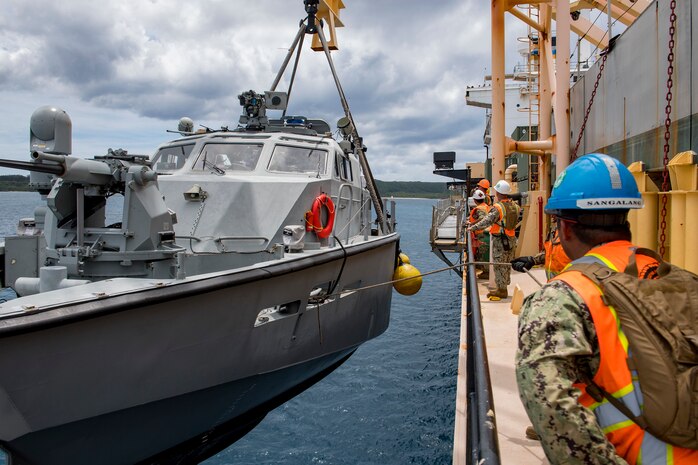 SANTA RITA, Guam (April 4, 2019) Sailors assigned to Navy Cargo Handling Battalion (NCHB) 1, Det. Guam, lift a Mark VI patrol boat assigned to Coastal Riverine Squadron (CRS) 2, Det. Guam, during a first-time proof of concept lift operation aboard the Military Sealift Command maritime prepositioning force ship USNS 2nd Lt. John P. Bobo (T-AK 3008). NCHB-1, Detachment Guam, assigned to Commander, Task Force 75, is the Navy's only active duty cargo handling battalion. They are a rapidly deployable unit of the Navy Expeditionary Combat Command, capable of loading and discharging ships and aircraft in all-climatic and threat conditions. (U.S. Navy photo by Mass Communication Specialist 2nd Class Jasen Moreno-Garcia/Released)