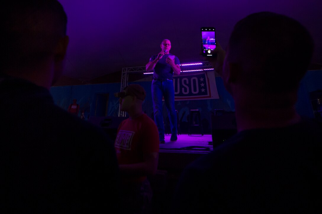 Chef Robert Irvine interacts with service members during the United Service Organizations (USO) tour April 1, 2019, at Al Udeid Air Base, Qatar. Irvine challenged a service member to complete push-ups before he could cook a meal during the show. U.S. Air Force Gen. Paul Selva, the Vice Chairman of the Joint Chiefs of Staff, hosted the tour alongside celebrities and performers including celebrities, perfomers and professional athletes.