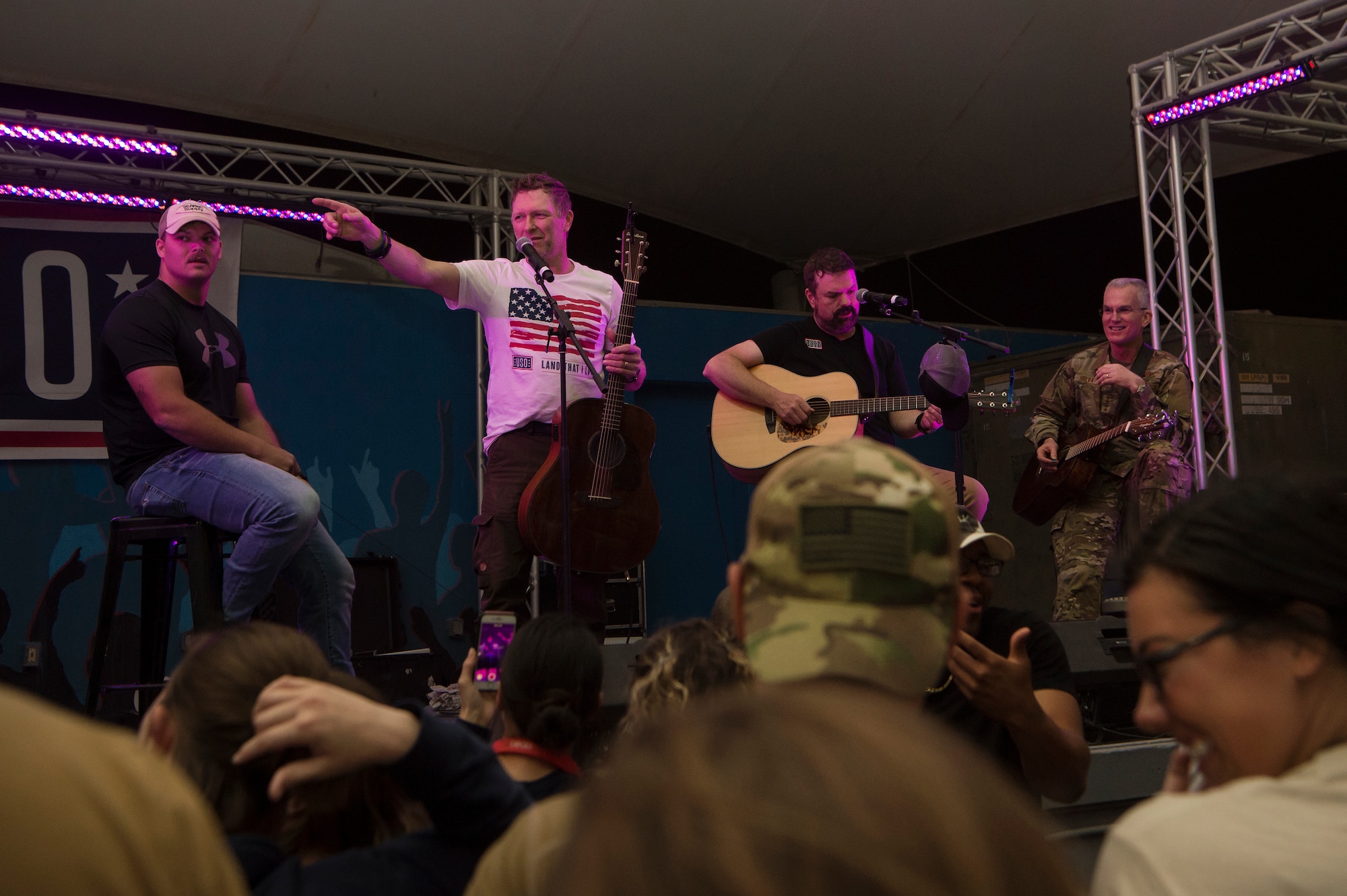 Craig Morgan, center left, country music singer and songwriter, interacts with service members alongside U.S. Air Force Gen. Paul Selva, right, Vice Chairman of the Joint Chiefs of Staff, during the United Service Organizations (USO) tour April 1, 2019, at Al Udeid Air Base, Qatar. Morgan invited service members to play guitar and sing alongside him during his performance. Selva hosted the tour alongside celebrities and performers including Morgan, Robert Irvine, and professional athletes.