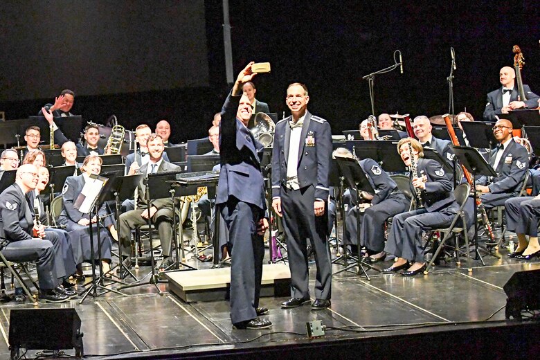 Col. Larry Shaw, 434th Air Refueling Wing commander, takes a selfie with the U.S. Air Force Band of Mid-America during their performance April 5, 2018 at McHale Auditorium in Logansport, Indiana. Each year the Band of Mid-America performs for millions of people throughout a 10-state region from the upper peninsula of Michigan to Arkansas. (U.S. Air Force photo/Douglas Hays)