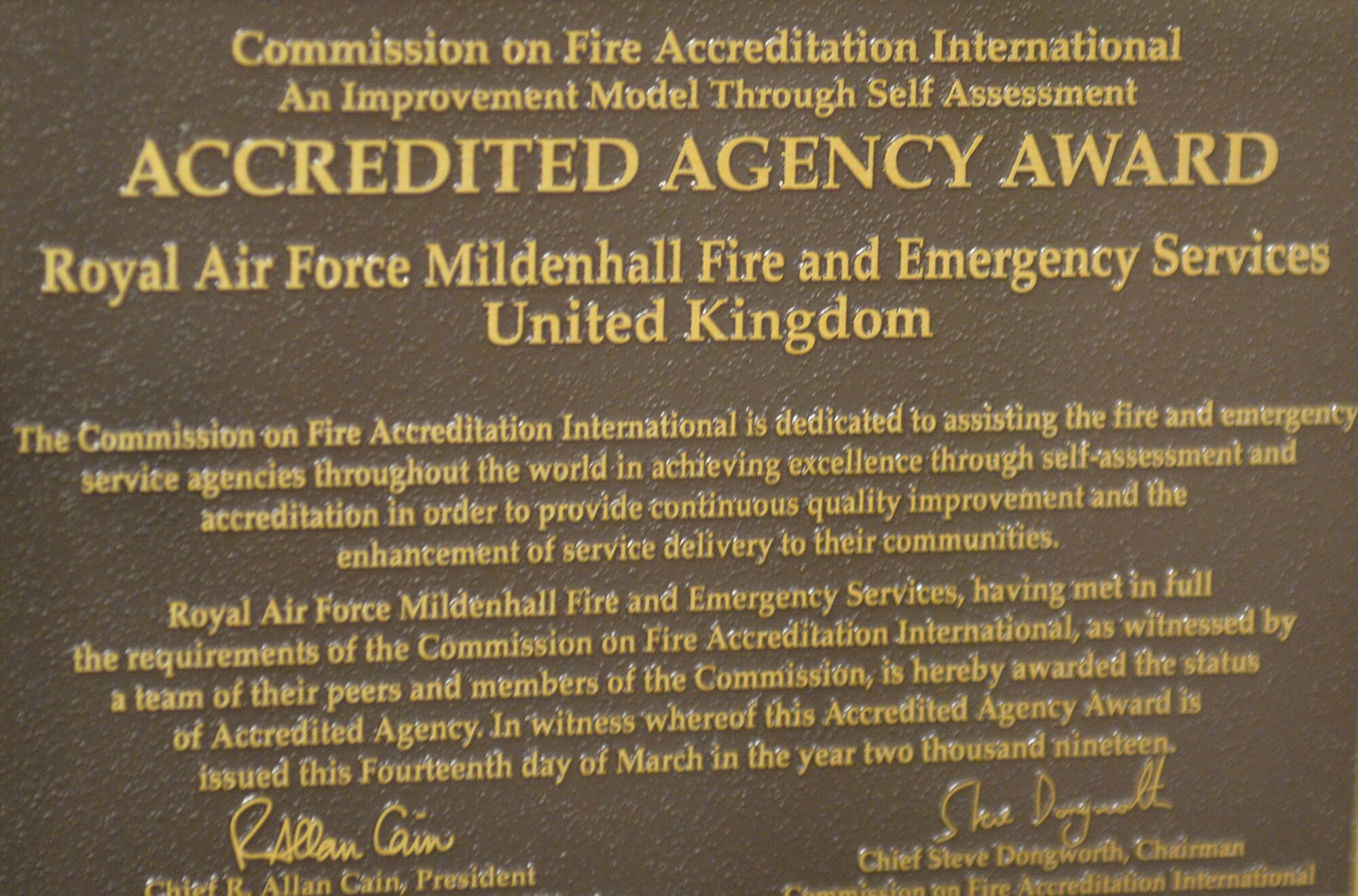 The Accredited Agency Award plaque was presented to the RAF Mildenhall Fire Department to show they went over and above in meeting all the requirements for this prestigious honor. In order to even be considered for accreditation, the fire department were inspected on more than 250 performance indicators and underwent a thorough peer assessment from a team of three municipal and one Department of Defense fire chiefs. (U.S. Air Force photo by Karen Abeyasekere)