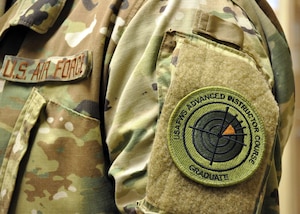 The 455th Air Expeditionary Wing intelligence flight chief is the first enlisted weapons school graduate to wear the new patch in Afghanistan. The patch was approved in October 2018. (U.S. Air Force photo by Capt. Anna-Marie Wyant)