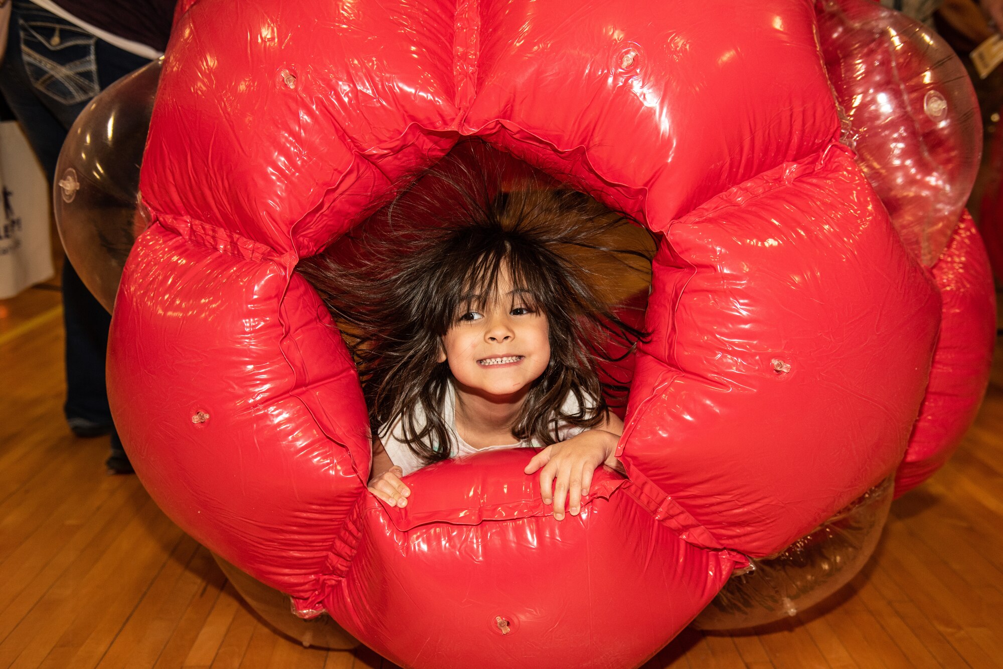 A child plays inside of an inflatable toy at the Month of the Military Child Celebration at Luke Air Force Base, Ariz., April 5, 2019. Several children took turns with games, face painting, a DJ and much more to celebrate the families of military members. (U.S. Air Force photo by Airman 1st Class Leala Marquez)