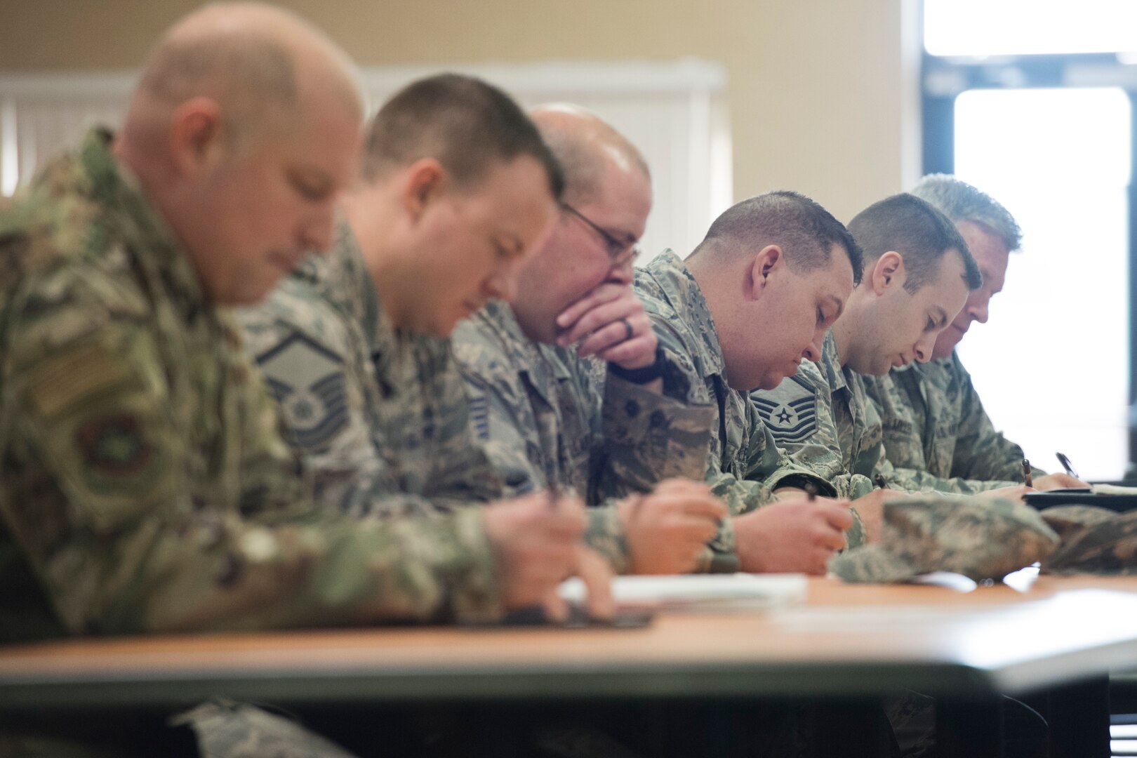 Airmen participating in the Homeland Security Exercise and Evaluation Program course fill out forms to receive their certification for completing the course. (U.S. Air National Guard photo by Senior Master Sgt. Emily Beightol-Deyerle)