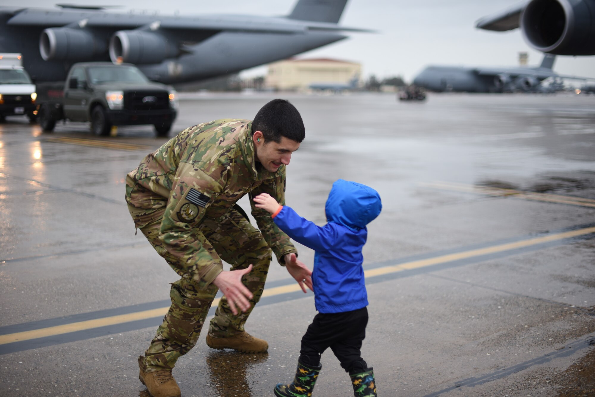 U.S. Air Force Maj. Thomas Neveu, 22nd Airlift Squadron C-5M pilot and multimodal stage manager, is greeted upon his return Feb. 25, 2019, by his family after returning to Travis Air Force Base, California, from a two-month deployment. Neveu and his team were part of an air bridge that transported U.S. Army cargo and personnel from Rota, Spain, to Afghanistan as part of a joint operation multimodal mission. (U.S. Air Force photos by Staff Sgt. Amber Carter)