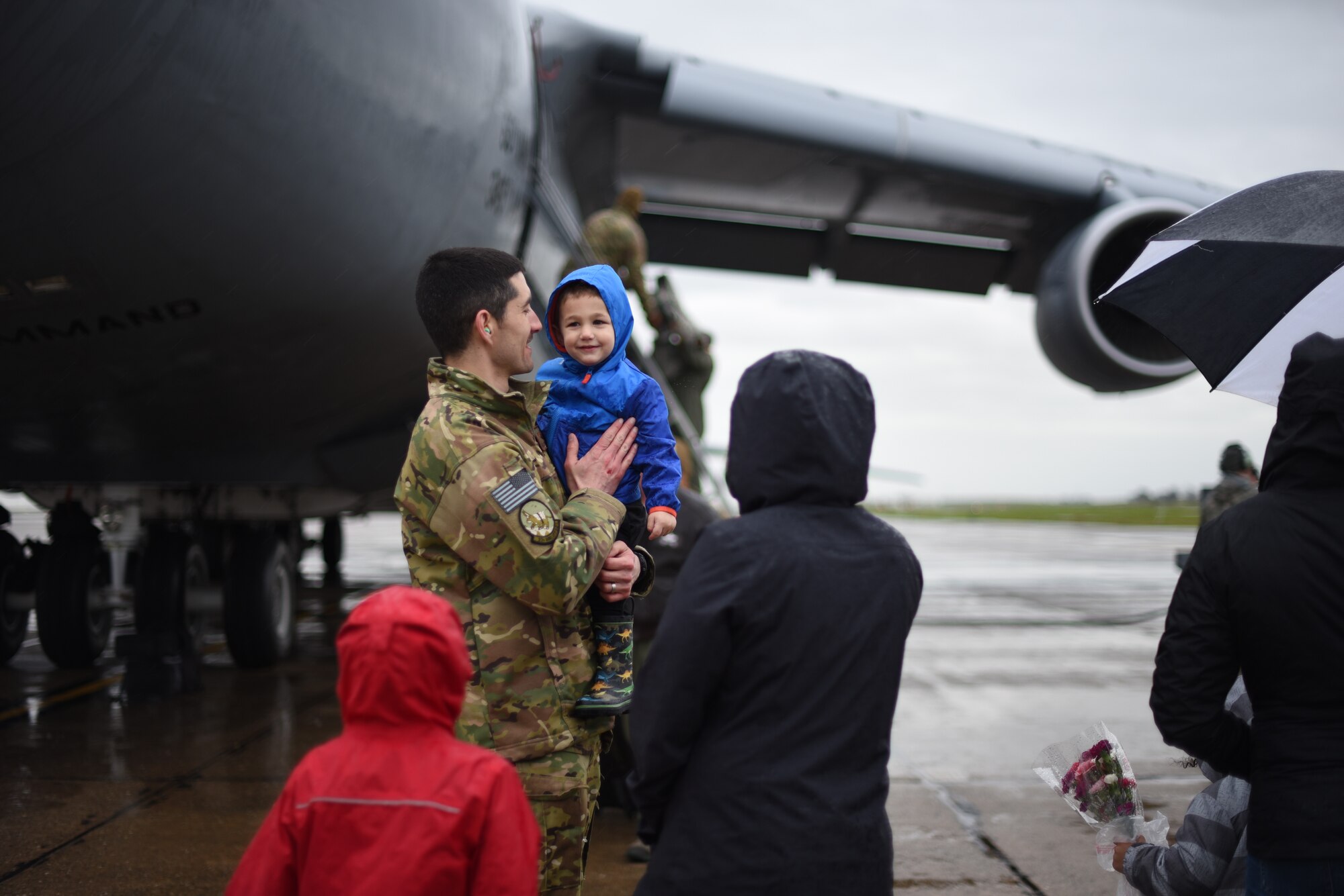 U.S. Air Force Maj. Thomas Neveu, 22nd Airlift Squadron C-5M pilot and multimodal stage manager, is greeted upon his return Feb. 25, 2019, by his family after returning to Travis Air Force Base, California, from a two-month deployment. Neveu and his team were part of an air bridge that transported U.S. Army cargo and personnel from Rota, Spain, to Afghanistan as part of a joint operation multimodal mission. (U.S. Air Force photos by Staff Sgt. Amber Carter)