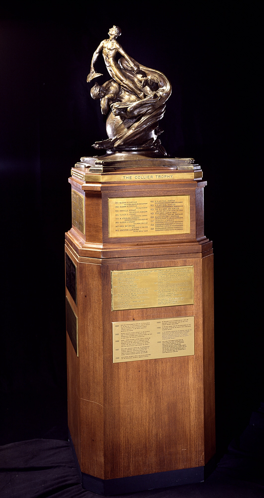 The Collier Trophy was established in 1911 by Robert J. Collier, publisher and early President of the Aero Club of America. The trophy is administered by the National Aeronautic Association of the U.S.A. and is awarded annually for "the greatest achievement in aeronautics or astronautics in America, with respect to improving the performance, efficiency, and safety of air or space vehicles, the value of which has been thoroughly demonstrated by actual use during the preceding year.” It is permanently housed at the Smithsonian National Air and Space Museum in Washington, D.C. (Photo courtesy of the Smithsonian Institution)
