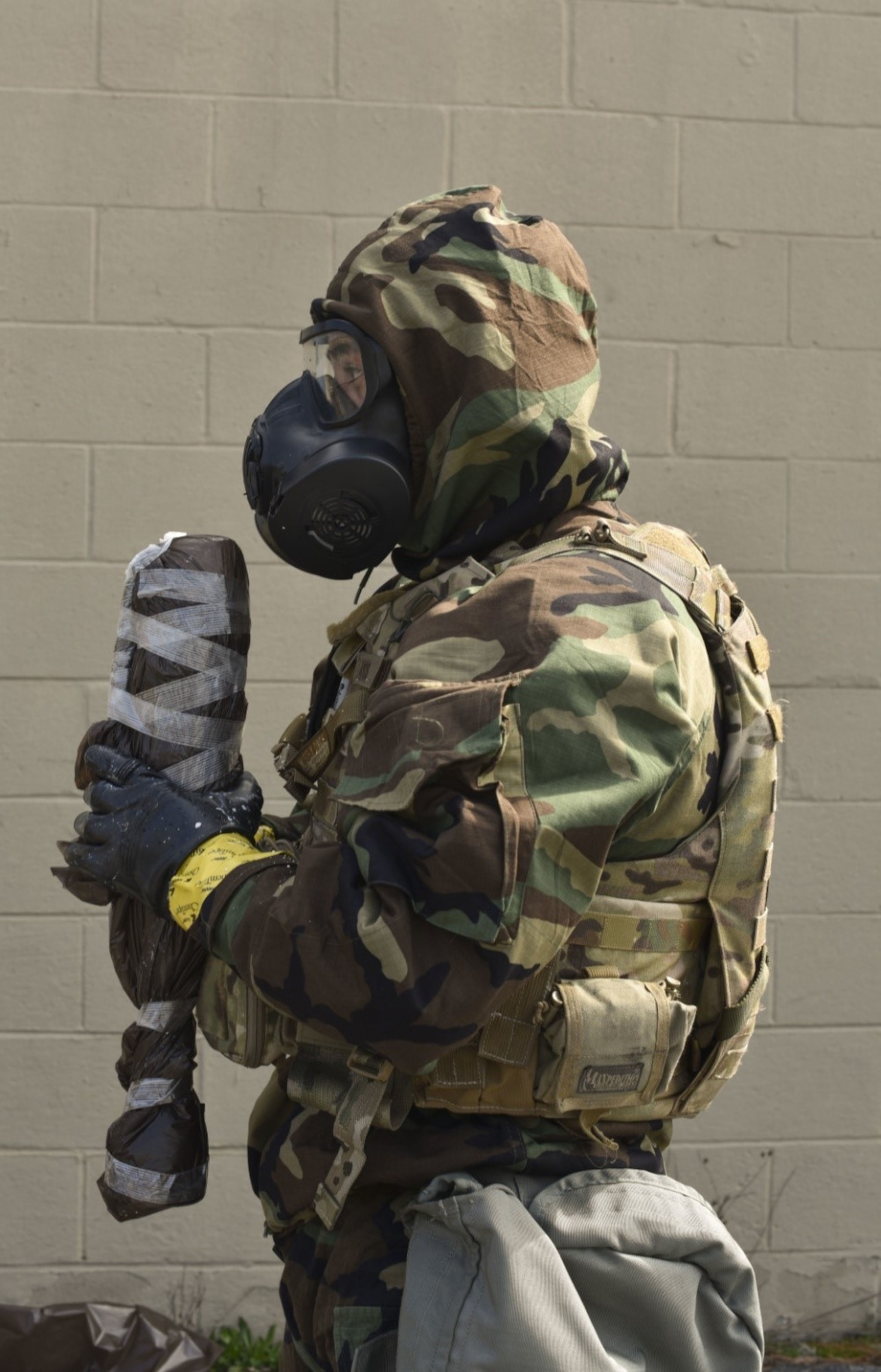 166th Airlift Wing explosive ordnance disposal technician Staff Sgt. Dominic Buckmuse keeps close hold of a decontaminated and sealed exercise munition at the New Castle Air National Guard Base April 7. A team of three Airmen worked in tandem to practice decontaminating, sealing and transporting potentially hazardous materials. These practice munitions are not harmful. In addition to supporting active duty overseas missions, the 166th EOD Flight supports several local counties. (U.S. Air Force Photo by Capt. Logan Clark)