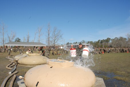 On March 14, 2019 Marine Corps Engineer School (MCES) hosted the annual St. Patrick’s Day Engineer Field Meet to pay homage to St. Patrick, the patron saint for engineers; build camaraderie amongst the engineer and utility communities, and compete for the Engineer Field Meet Trophy. Marines competing in the Water Bucket Relay sprinted across Ellis Field with empty buckets to water bladders, filled the buckets, and then sprinted back across Ellis Field in order to be the first team to fill a 55-gallon trash can.