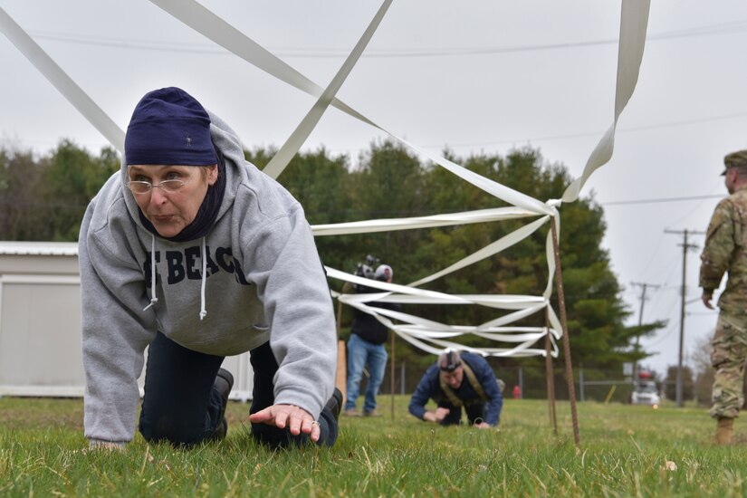 Honorary Commander Ellen McDermott crawls through an Army obstacle course at Joint Base McGuire-Dix-Lakehurst, New Jersey, April 5, 2019.  Members of the Honorary Commander program are able to experience a small taste of military life, showing the training service members have to complete.  (U.S. Air Force photo by 1st Lt. Jaclyn Sumayao)