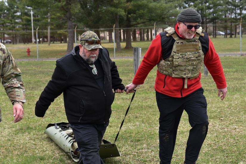 Honorary Commanders Daniel Dewey and Gary Fish team up to pull a combat trauma mannequin at Joint Base McGuire-Dix-Lakehurst, New Jersey, April 5, 2019.  Being exposed to this type of training gives key community leaders a better understanding of how military members prepare for combat.  (U.S. Air Force photo by 1st Lt. Jaclyn Sumayao)
