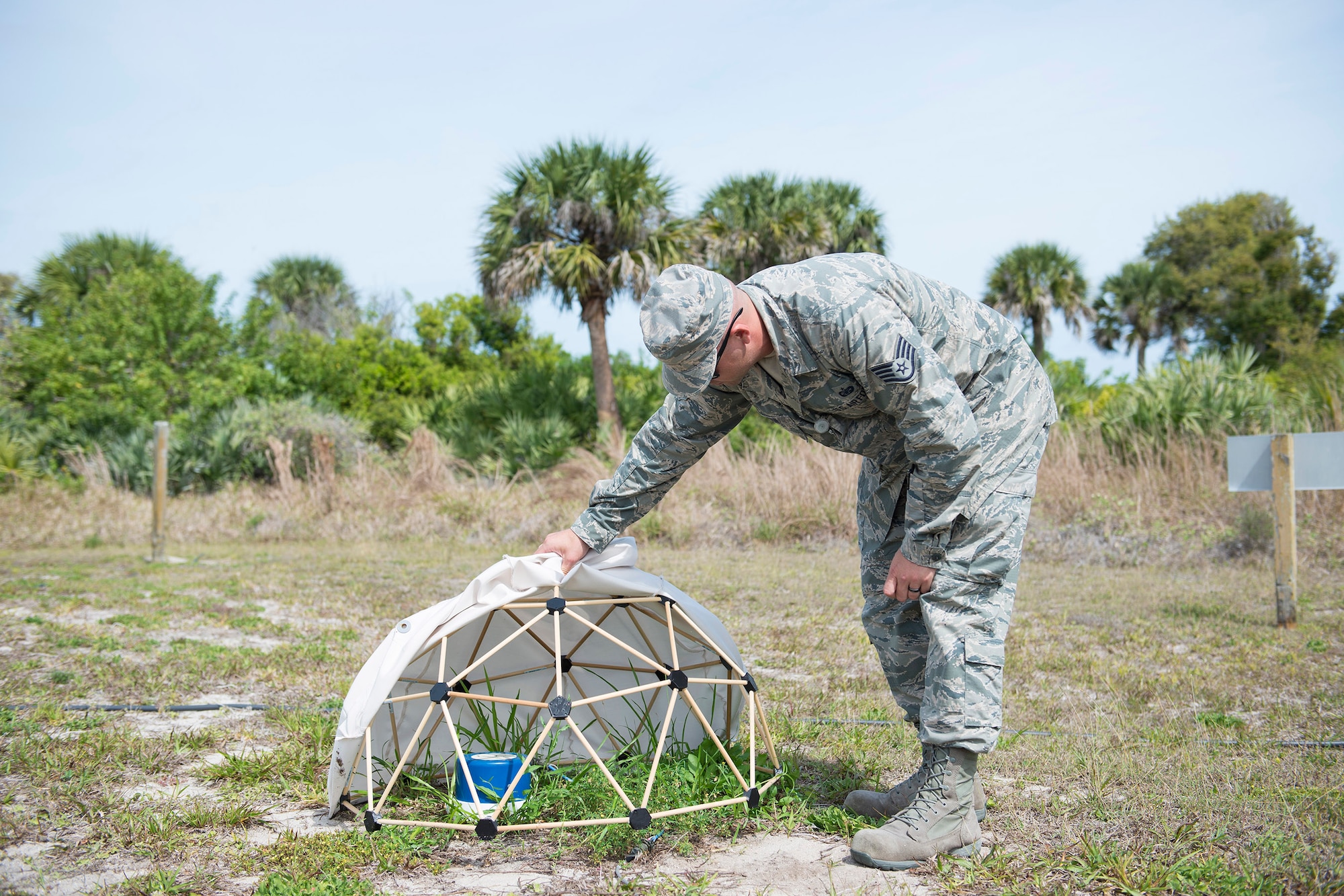 U.S. Air Force Staff Sgt. Derrick C. Johnson, a field test technician assigned to the Systems Development Directorate at the Air Force Technical Applications Center, Patrick Air Force Base, Florida, lifts the fabric from a small geodesic dome he developed to collect hydroacoustic data. (U.S. Air Force photo by Matthew S. Jurgens)