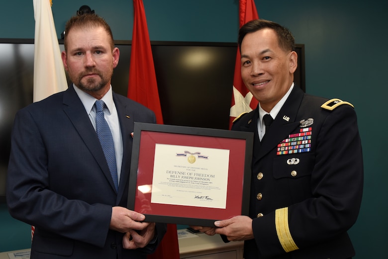 Maj. Gen. Mark Toy, U.S. Army Corps of Engineers Great Lakes and Ohio River Division commander, presents the Secretary of Defense Medal for the Defense of Freedom April 8, 2019 to Billy Johnson, recognizing the severe injuries he sustained while supporting a Corps of Engineers mission as a security officer in Iraq Dec. 9, 2007. The general presented the medal on behalf of Secretary of the Army Mark T. Esper during a ceremony held at the Tennessee Valley Authority Central Labs near Chickamauga Lock in Chattanooga, Tenn. (USACE photo by Lee Roberts)