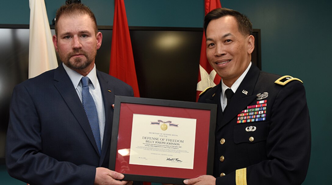 Maj. Gen. Mark Toy, U.S. Army Corps of Engineers Great Lakes and Ohio River Division commander, presents the Secretary of Defense Medal for the Defense of Freedom April 8, 2019 to Billy Johnson, recognizing the severe injuries he sustained while supporting a Corps of Engineers mission as a security officer in Iraq Dec. 9, 2007. The general presented the medal on behalf of Secretary of the Army Mark T. Esper during a ceremony held at the Tennessee Valley Authority Central Labs near Chickamauga Lock in Chattanooga, Tenn. (USACE photo by Lee Roberts)