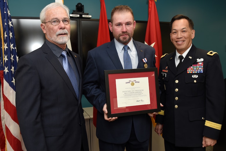 Maj. Gen. Mark Toy, U.S. Army Corps of Engineers Great Lakes and Ohio River Division commander, poses with Billy Johnson, who received the Secretary of Defense Medal for the Defense of Freedom, recognizing the severe injuries he sustained while supporting a Corps of Engineers mission as a security officer in Iraq Dec. 9, 2007, and Phillip Gonzales, a U.S. Army Special Forces medic.  Gonzales submitted Johnson for the Defense of Freedom Medal. The general presented the medal April 8, 2019 on behalf of Secretary of the Army Mark T. Esper during a ceremony held at the Tennessee Valley Authority Central Labs near Chickamauga Lock in Chattanooga, Tenn. (USACE photo by Lee Roberts)