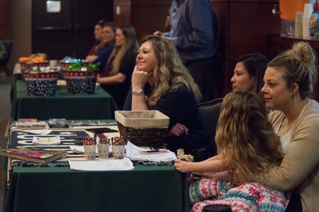 Volunteers and staff from the USO and the Armed Services YMCA of Alaska listen to other resource providers during a welcome reception at Joint Base Elmendorf-Richardson, Alaska, April 8, 2019. The JBER Support to Tyndall Airmen and Families Reception was a one-stop information fair connecting them with the appropriate agencies to address their immediate and specific needs and to learn more about services they offer.