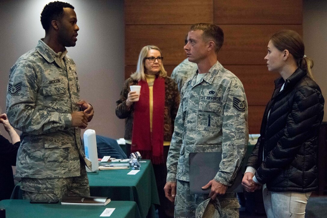 U.S. Air Force Staff Sgt. Terrence Jackson, a 673d Comptroller Squadron financial management specialist, speaks with Tech. Sgt. Justin Torrey, a 525th Aircraft Maintenance Squadron weapons load crew chief and his wife Olena Semyletko, during a welcome reception at Joint Base Elmendorf-Richardson, Alaska, April 8, 2019. The JBER Support to Tyndall Airmen and Families Reception was a one-stop information fair connecting them with the appropriate agencies to address their immediate and specific needs and to learn more about services they offer.