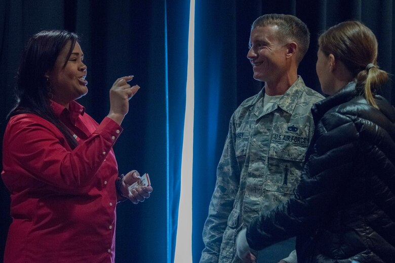 Paola Pacheco, a Military One Source state consultant, speaks with U.S. Air Force Tech. Sgt. Justin Torrey, a 525th Aircraft Maintenance Squadron weapons load crew chief and wife Olena Semyletko during a welcome reception at Joint Base Elmendorf-Richardson, Alaska, April 8, 2019. The JBER Support to Tyndall Airmen and Families Reception was a one-stop information fair connecting them with the appropriate agencies to address their immediate and specific needs and to learn more about services they offer.