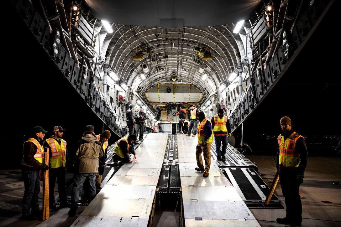 Men in transport jet’s cargo bay.