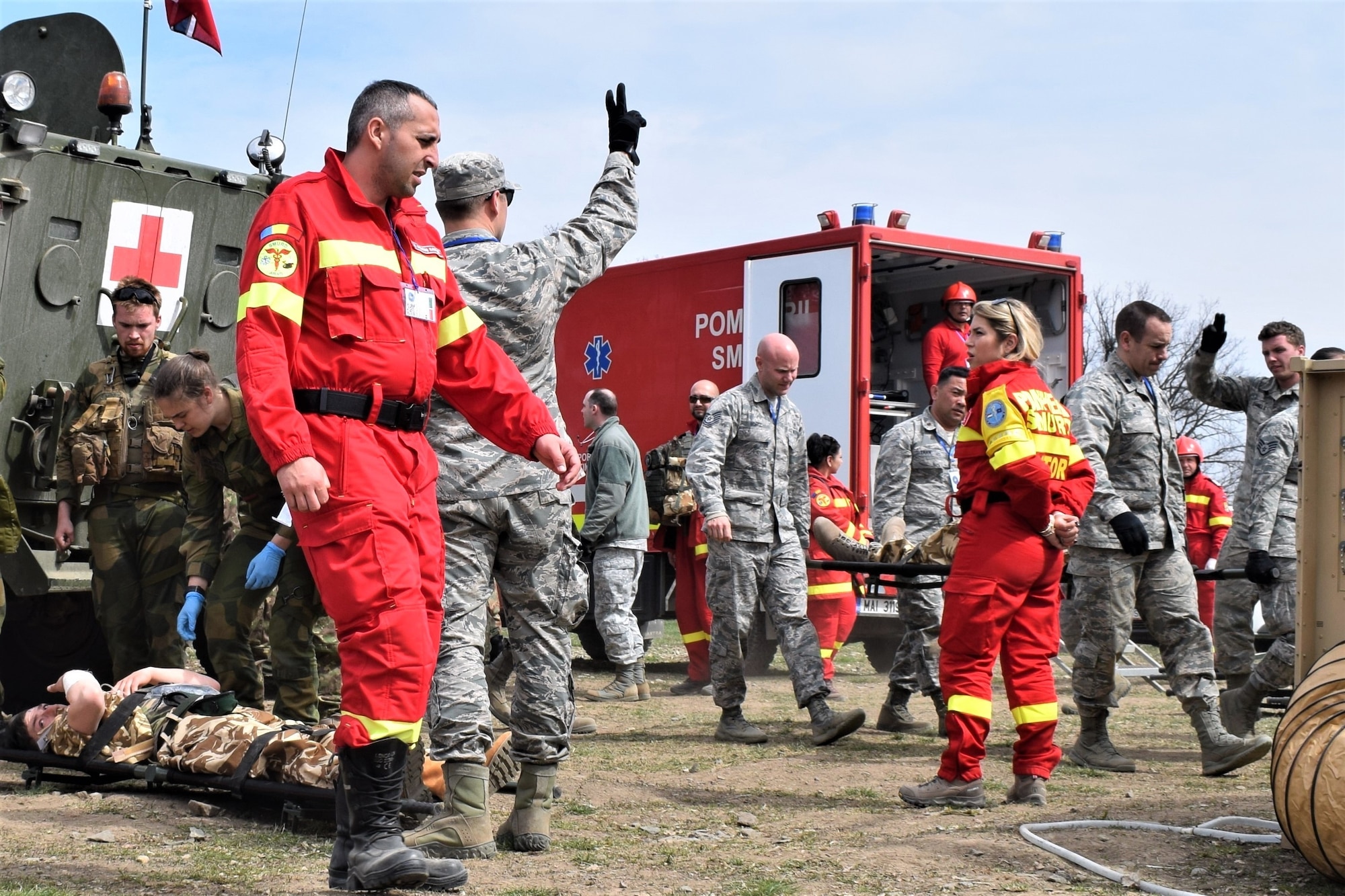 Civilian first responders from Romania participate along with Airmen from the 86th Medical Group, Ramstein Air Base, Germany, in a multinational medical exercise drill during Vigorous Warrior 19, Cincu Military Base, Romania, April 8, 2019. Vigorous Warrior 19 is NATO’s largest-ever military medical exercise, uniting more than 2,500 participants from 39 countries to exercise experimental doctrinal concepts and test their medical assets together in a dynamic, multinational environment. (U.S. Air Force photo by 1st Lt. Andrew Layton)