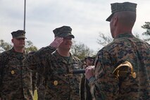 U.S. Navy Master Chief Petty Officer Richard A. Jackson, on-coming command master chief of 2nd Marine Logistics Group, salutes Brig. Gen. Kevin Stewart, commanding general of 2nd MLG during a change of charge ceremony at Camp Lejeune, N. C., April 4, 2019. Master Chief Petty Officer Christopher Rebana was relieved by Master Chief Petty Officer Richard A. Jackson as command master chief of 2nd MLG. (U.S. Marine Corps photo by Lance Cpl. Scott Jenkins)