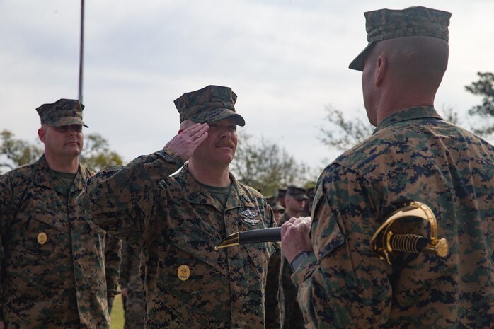 U.S. Navy Master Chief Petty Officer Richard A. Jackson, on-coming command master chief of 2nd Marine Logistics Group, salutes Brig. Gen. Kevin Stewart, commanding general of 2nd MLG during a change of charge ceremony at Camp Lejeune, N. C., April 4, 2019. Master Chief Petty Officer Christopher Rebana was relieved by Master Chief Petty Officer Richard A. Jackson as command master chief of 2nd MLG. (U.S. Marine Corps photo by Lance Cpl. Scott Jenkins)