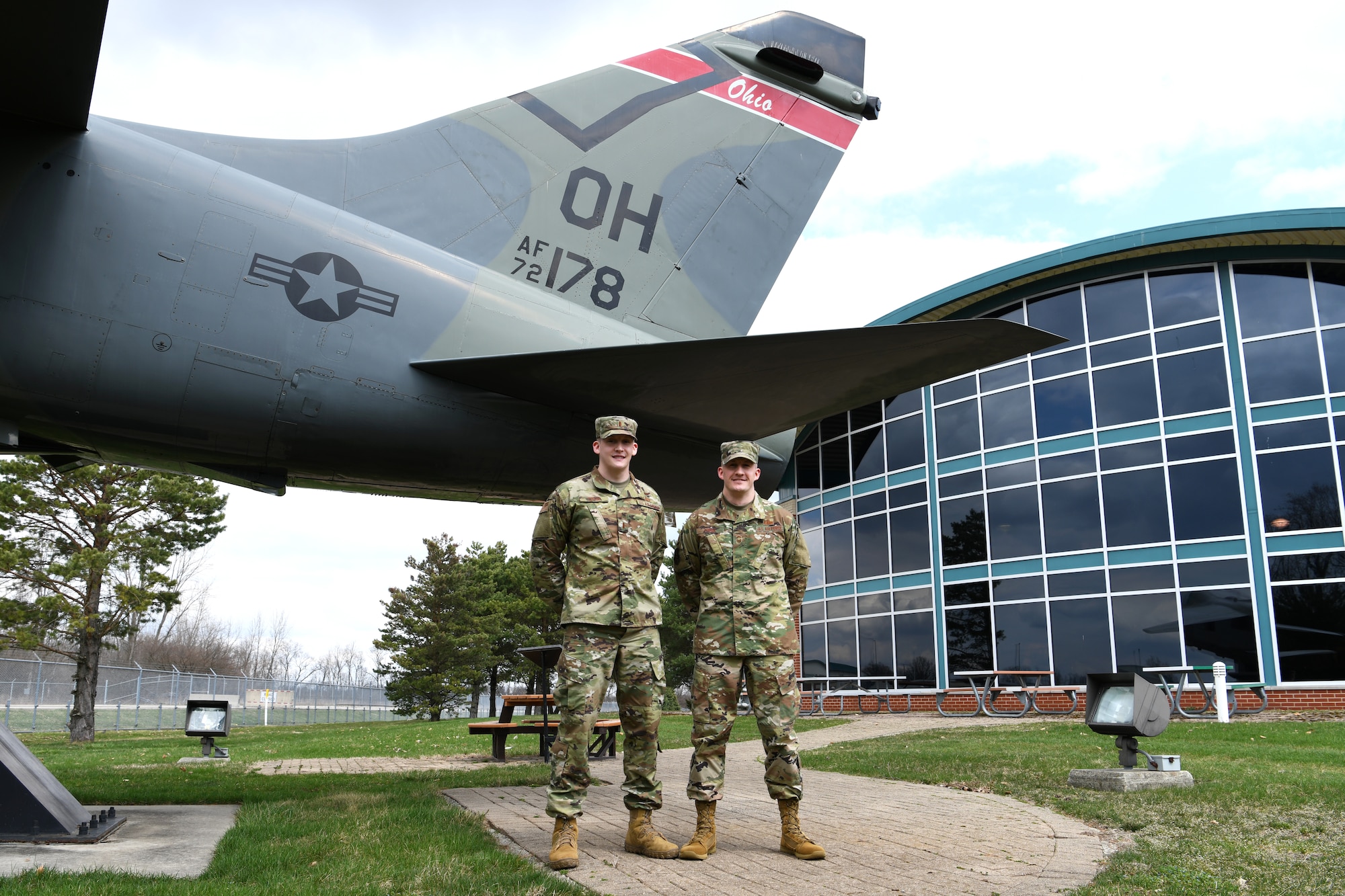 photo of Crum brothers in front of static display