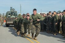 U.S. Marines with 8th Engineer Support Battalion, 2nd Marine Logistics Group, pull a Backhoe Loader while competing in the Marine Corps Engineer School Saint Patrick’s Day Field Meet on Camp Lejeune, North Carolina, March 14, 2019. Marines competed in the field meet to strengthen community and camaraderie in the spirit of friendly competition.