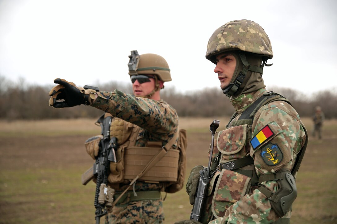 A U.S. Marine with Special Purpose Marine Air-Ground Task Force-Crisis Response-Africa 19.1, Marine Forces Europe and Africa, explains breaching tenants to soldiers of the Romanian army's 341st Infantry Battalion during Platinum Eagle 19.1, a multilateral training exercise held at Babadag Training Area, Romania, March 15, 2019.