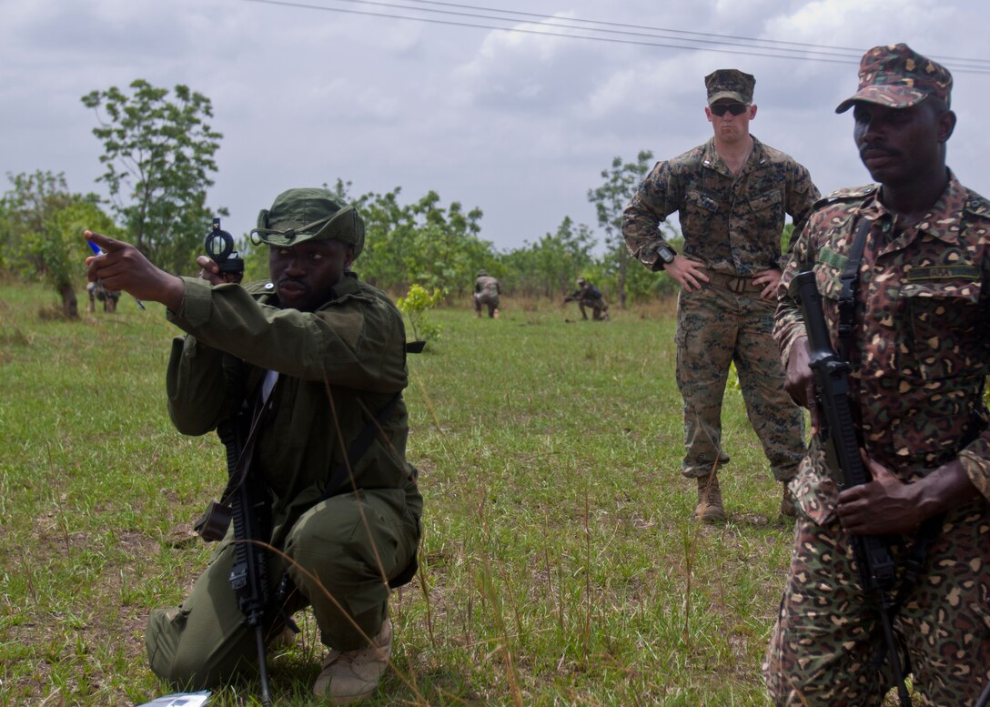 Members of the Ghanaian ministry of the interior conduct a patrolling exercise while a U.S. Marine with Special Purpose Marine Air-Ground Task Force-Crisis Response-Africa 19.1, Marine Forces Europe and Africa, supervises during a theater-security cooperation event in Asutsuare, Ghana, March 19, 2019.