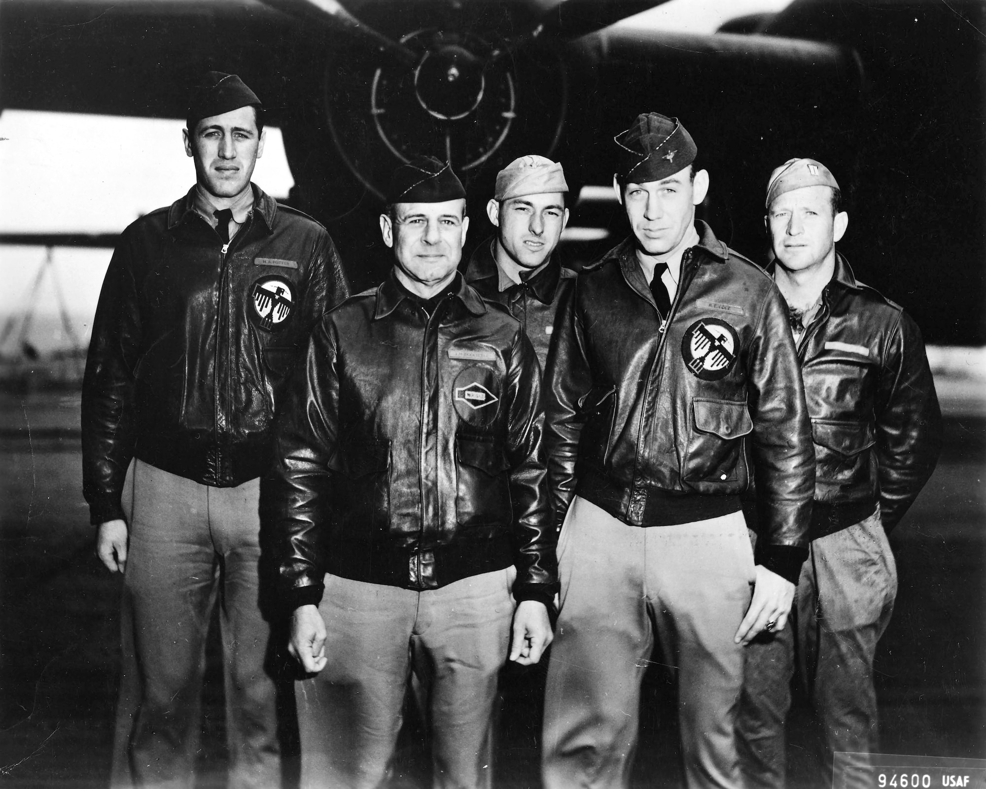 Five people in front of a B-25 Mitchell bomber.
