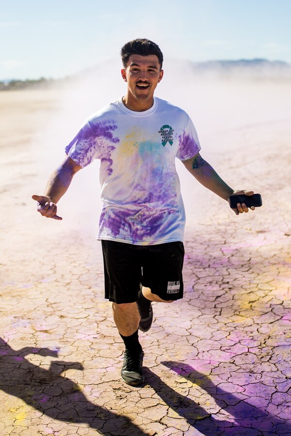 A Participant takes part in the fifth annual Colorful Consent Run on Marine Corps Air Ground Combat Center, Twentynine Palms, Calif,. April 5th, 2019. The 3.2 mile (5 kilometer) run took place in April, Sexual Assault Awareness Month. (U.S. Marine Corps photograph by Pfc. Cedar Barnes)