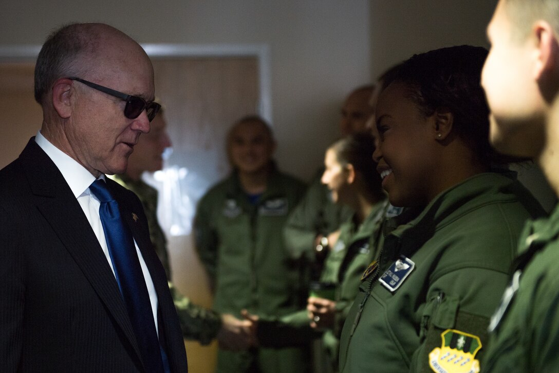 U.S. Ambassador to the U.K. Robert Wood Johnson (left), meets Capt. Austyn Wilson (right), 20th Bomb Squadron weapons system officer deployed from Barksdale Air Force Base, La., during a visit to RAF Fairford, England, March 29, 2019. Johnson visited the base during a U.S. Strategic Command Bomber Task Force in Europe. (U.S. Air Force photo by Airman 1st Class Tessa B. Corrick)