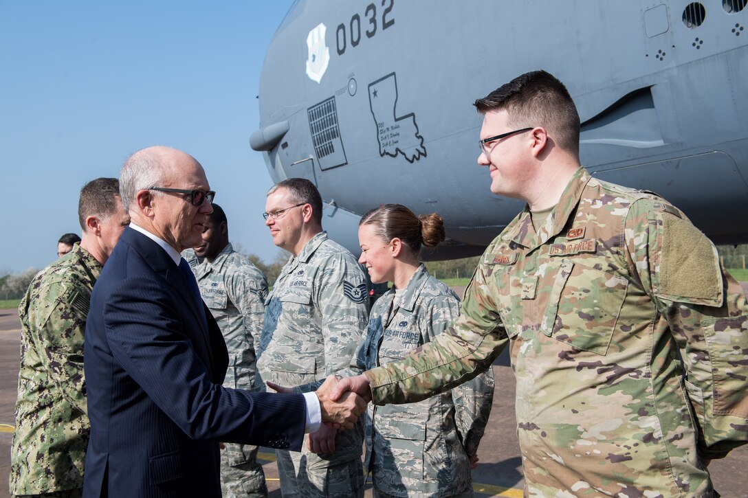 U.S. Ambassador to the U.K. Robert Wood Johnson (left), shakes hands with Airmen deployed from Barksdale Air Force Base, La., during a visit to RAF Fairford, England, March 29, 2019. To conclude his time at RAF Fairford, Johnson was given a static tour of a B-52 Stratofortress. (U.S. Air Force photo by Airman 1st Class Tessa B. Corrick)