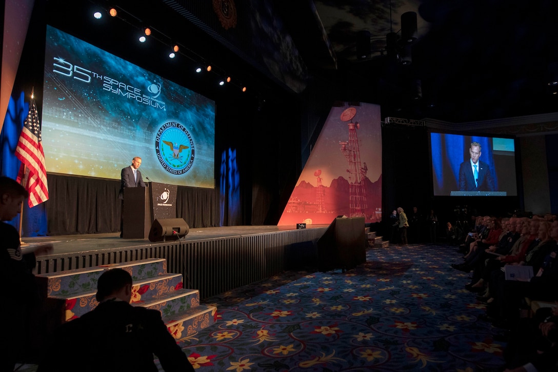 Acting Defense Secretary Patrick M. Shanahan speaks from behind a podium on a stage.