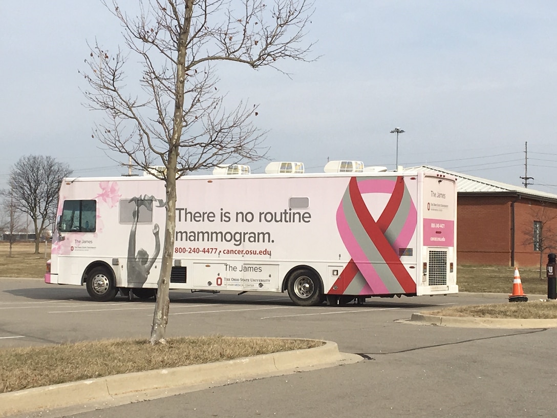 Pink bus in parking lot