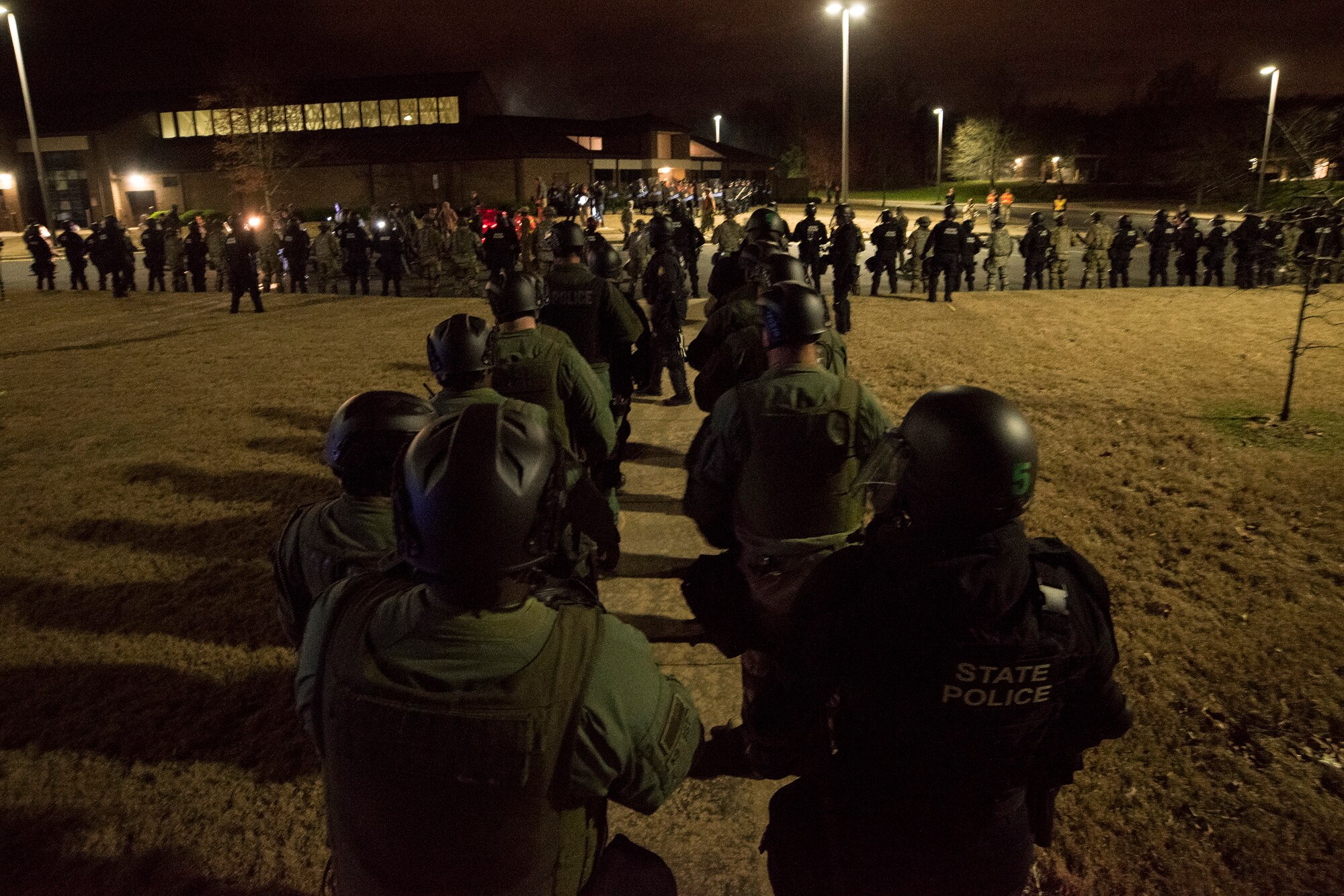 Arkansas National Guard and Arkansas State Police members form a crowd control line during Operation Phalanx, March 30-31, 2019, at Little Rock Air Force Base, Arkansas. The operation is a joint exercise hosted by the Arkansas National Guard for civilian and military organizations to train their members in tactics and techniques used in responding to a civil disturbance. (U.S. Air National Guard photo by Staff Sgt. Matthew Matlock)