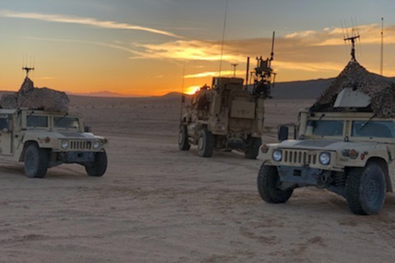 Military vehicles parked in desert