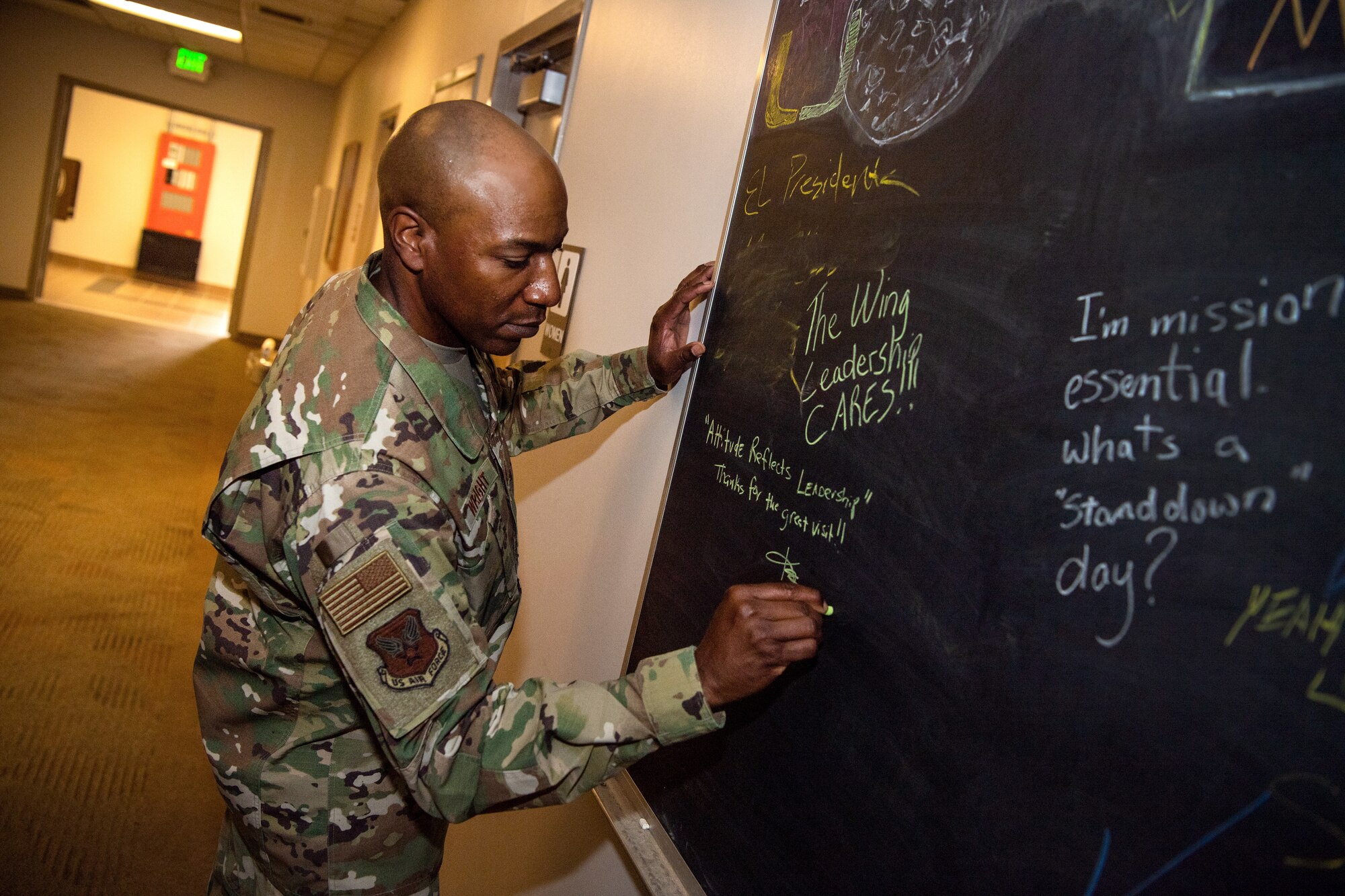 Chief Master Sgt. of the Air Force Kaleth O. Wright writes a message to Team Schriever on the 50th Space Wing Chapel Office’s message board in Building 300, Schriever Air Force Base, Colorado, April 9, 2019. The 50th Space Wing exhibited their mission, vision and priorities to Wright as he visited various units across the installation. (U.S. Air Force photo by Katie Calvert)