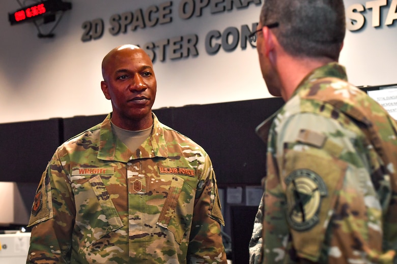 Chief Master Sgt. of the Air Force Kaleth O. Wright listens to a Maj. Matthew Miller 2nd Space Operations Squadron and 19th Space Operations Squadron, crew commander, explains his role in the 2nd SOPS mission, at Schriever Air Force Base, Colorado, April 9, 2019. Wright saw how 2nd SOPS conducts integrated and innovative operations in their mission. (U.S. Air Force photo by Katie Calvert)